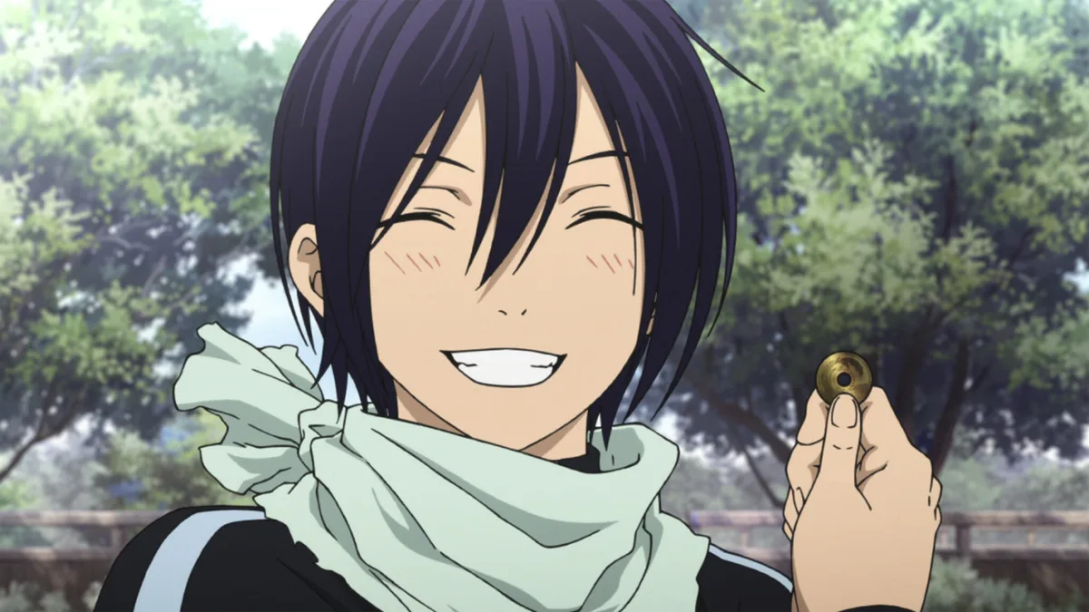Yato holding up a coin and smiling in Noragami