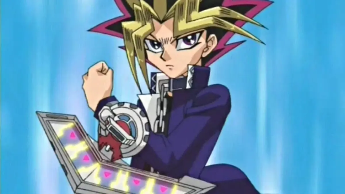 Yugi wielding the duel desk against a bright blue background from the original Yu-Gi-Oh! anime